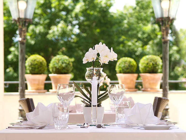 Elegant gedeckter Tisch auf der Sonnenterrasse des Hotel Oswald im Bayerischen Wald.